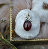 PENDANT, A Pool of Garnet Wrapped in Bows