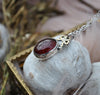 PENDANT, A Pool of Garnet Wrapped in Bows