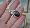 PENDANT, A Pool of Garnet Wrapped in Bows
