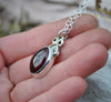 PENDANT, A Pool of Garnet Wrapped in Bows